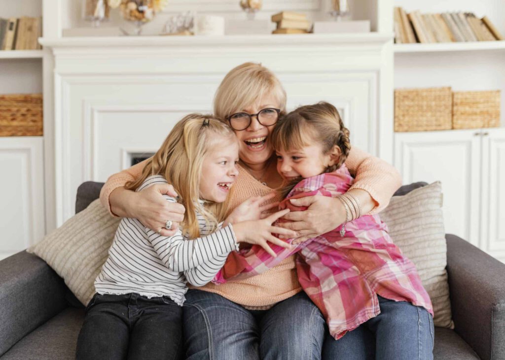 medium shot grandmother girls scaled